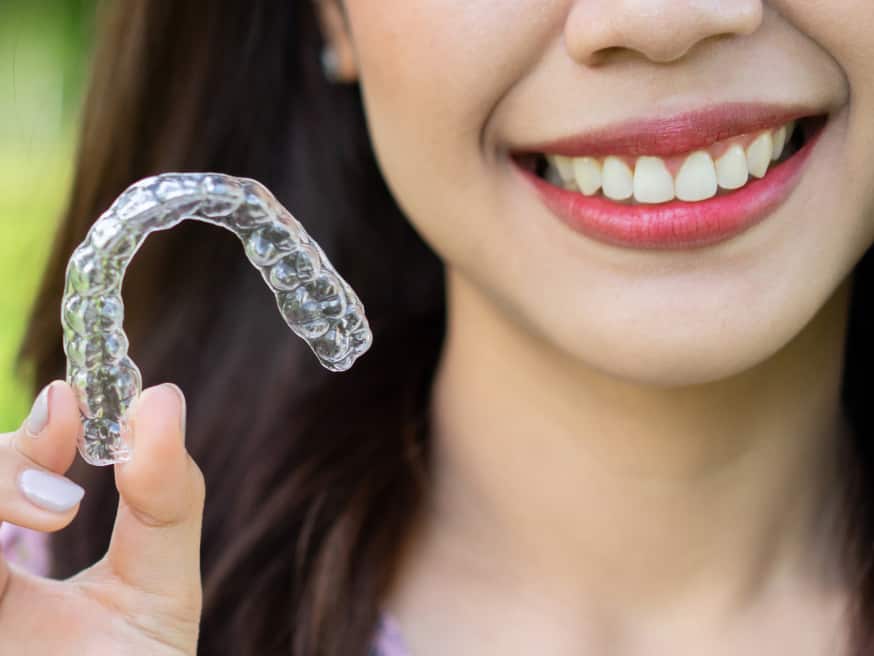 Girl holding invisalign